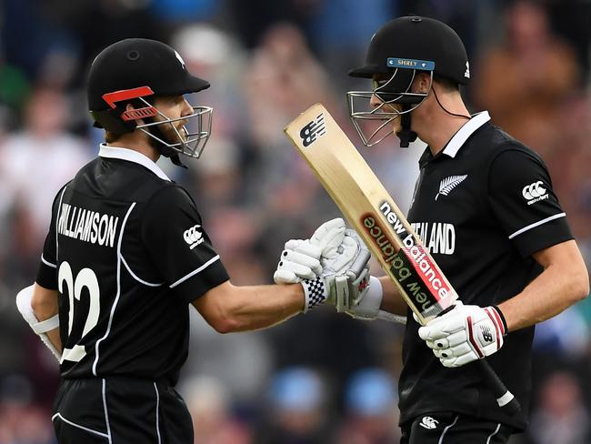 Kane Williamson and Mitchell Santner celebrate their four-wicket victory.