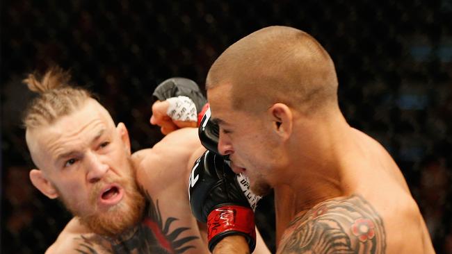 Conor McGregor punches Dustin Poirier at UFC 178 in 2014. Picture: Josh Hedges/Zuffa LLC/Zuffa LLC via Getty