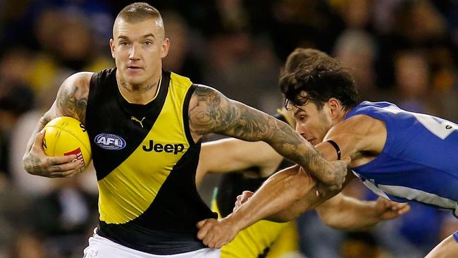 MELBOURNE, VICTORIA - MAY 13:  Dustin Martin of the Tigers runs with the ball during the round eight AFL match between the North Melbourne Kangaroos and the Richmond Tigers at Etihad Stadium on May 13, 2018 in Melbourne, Australia.  (Photo by Darrian Traynor/AFL Media/Getty Images)