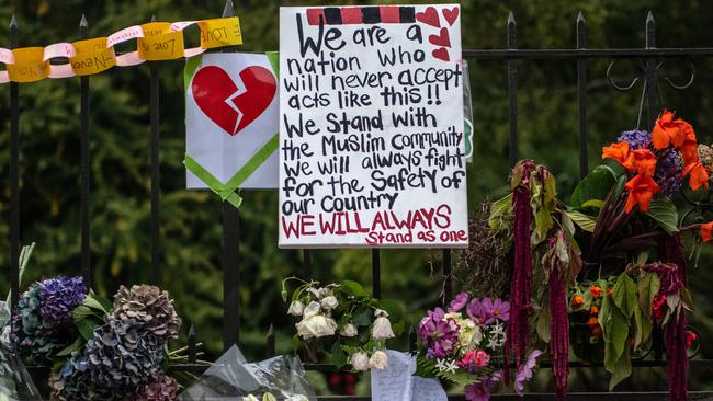 Flowers and tributes are hung on the fence of the Botanic Gardens in Christchurch. Picture: Getty Images.