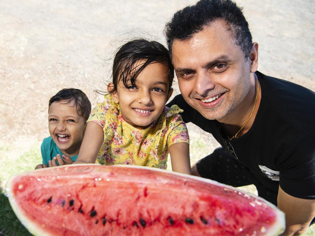 Avishek Khanal with son Amish and daughter Avika Khanal pick up juicy watermelon from the Toowoomba Farmers Markets, Saturday, January 7, 2023.