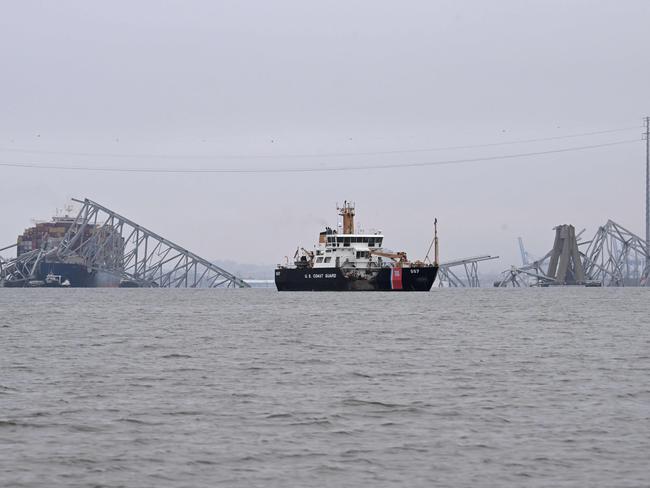 A US Coast Guard boat patrols near the collapsed Francis Scott Key Bridge. Picture: AFP