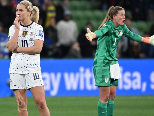 USA's midfielder #10 Lindsey Horan (L) and USA's goalkeeper #01 Alyssa Naeher (R) react at the end of the Australia and New Zealand 2023 Women's World Cup round of 16 football match between Sweden and USA at Melbourne Rectangular Stadium in Melbourne on August 6, 2023. (Photo by WILLIAM WEST / AFP)