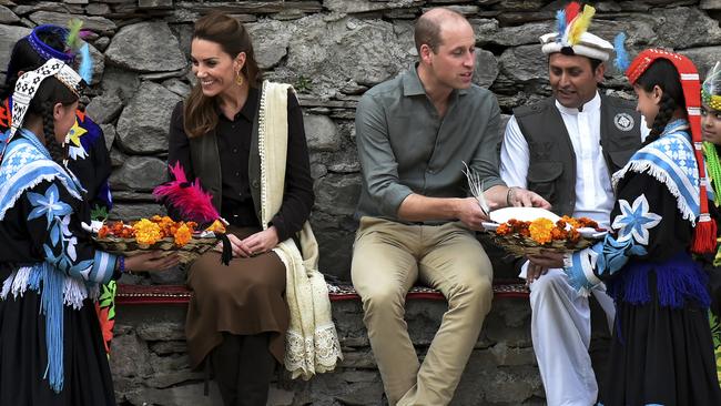 Members of the Kalash community greet William and Kate in the Bumburate Valley, Pakistan. Picture: AP.