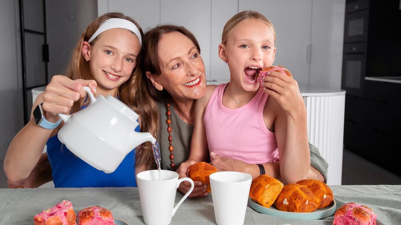 L-R, Ella 11, Grandma Deb and Ava, 9 try Coles’ new hot cross buns. Picture Rebecca Michael.