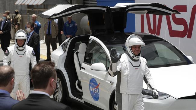 NASA astronauts drive a Tesla SUV to the launch pad for the SpaceX test flight. Picture: AP Photo/John Raoux.