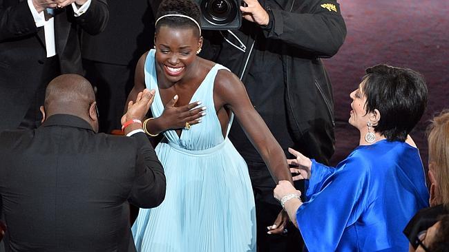 Liza Minnelli grabs Lupita Nyong'o for no apparent reason after winning an Oscar. (Photo by Kevin Winter/Getty Images)