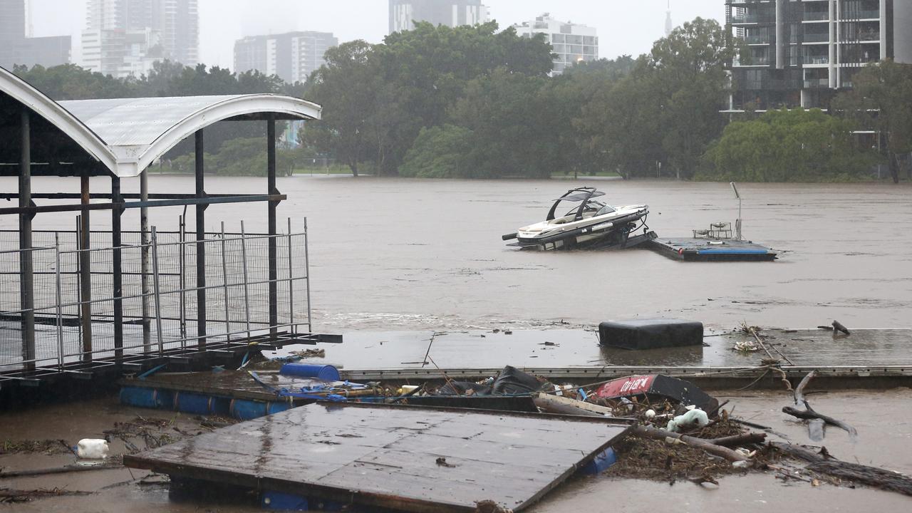 A boat and drifts past the old coating restaurant, in the Brisbane river. Photo: Steve Pohlner