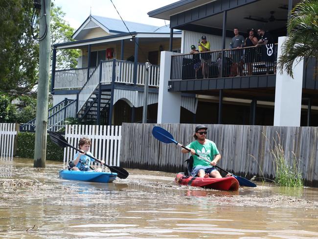 Residents kayak down a street in Tumbulgum, northern NSW on Tuesday. Picture: AAP