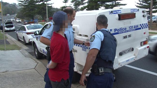 Police take one of the youths into custody for questioning. Picture: TNV