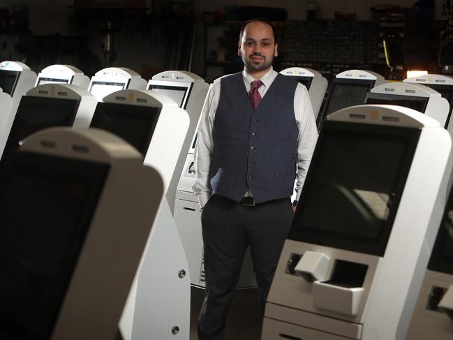 Aaron Hornlimann, CEO of Elenium Automation, with new torchless check-in scanning machine which also checks your body temperature. Picture: Stuart McEvoy.