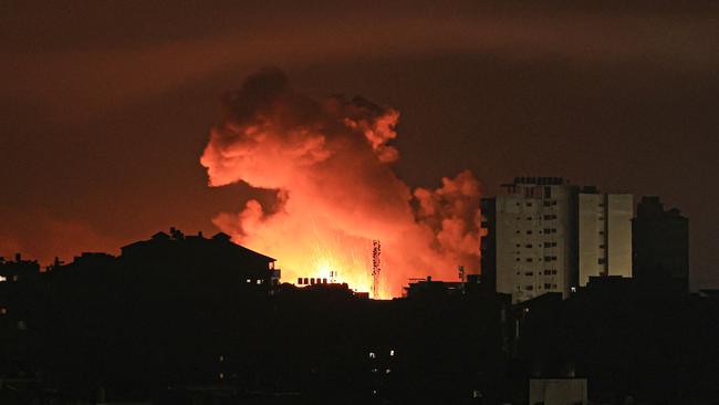 Fire and smoke rise above buildings in Gaza City during an Israeli air strike. War leaves lasting scars on its victims and the landscape. But the markets tend to bounce back quickly. Picture: AFP