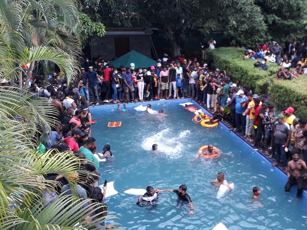 Protestors demanding the resignation of Sri Lanka's President Gotabaya Rajapaksa swim in a pool inside the compound of Sri Lanka's Presidential Palace in Colombo on July 9, 2022. Picture: AFP