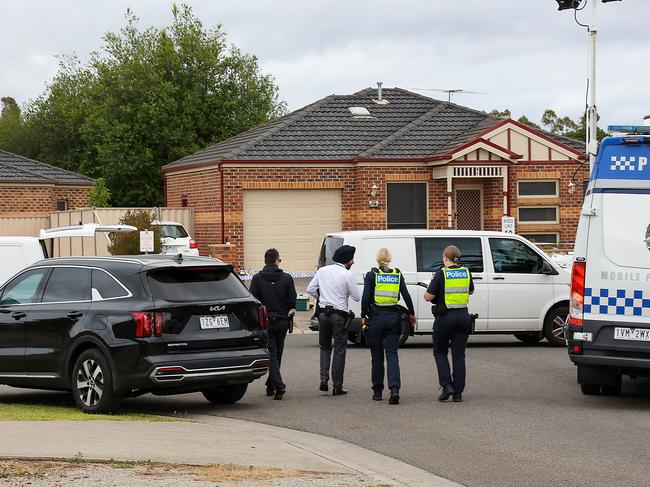 Investigators cordon off the street. Picture: Ian Currie