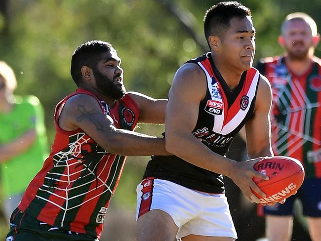 Para's Win Thach is tackled by Pines' Robert Pinkie at the North Pines vs Para Hills  amateur football league game, in Parafield Gardenspicture: Bianca De Marchi