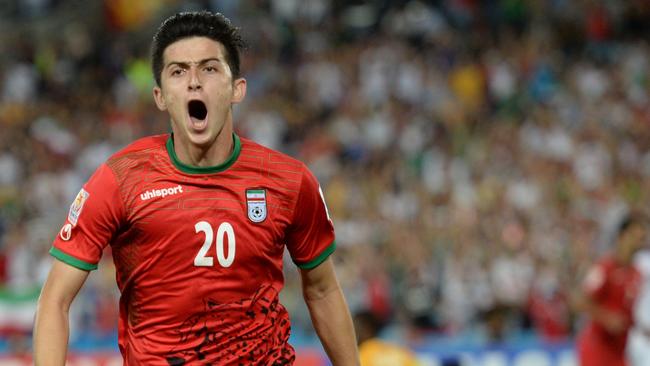 Sardar Azmoun of Iran (C) celebrates scoring the opening goal against Qatar in their Group C football match in the AFC Asian Cup in Sydney on January 15, 2015. AFP PHOTO/Peter PARKS --IMAGE RESTRICTED TO EDITORIAL USE - STRICTLY NO COMMERCIAL USE