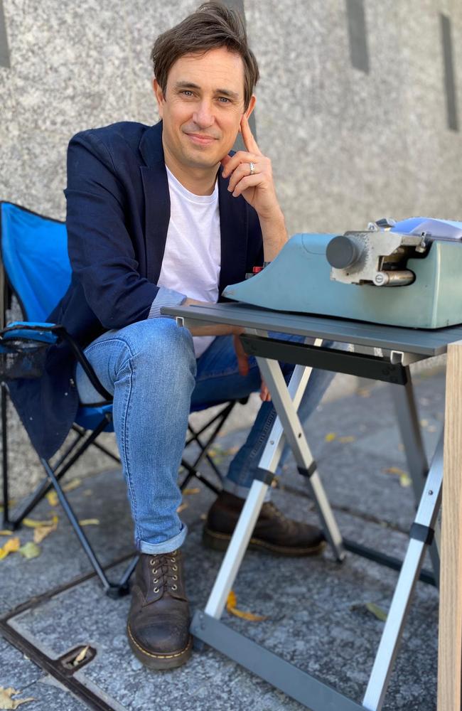 Tretn Dalton sittign with his typewriter in Brisbane CBD.