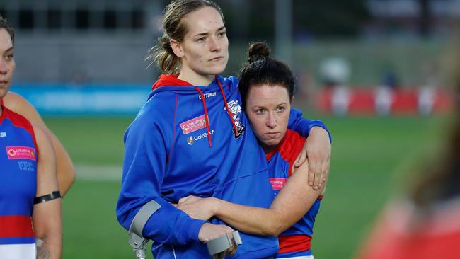 Isabel Huntington (left) is consoled by teammate Brooke Lochland after her latest ACL injury. Picture: AFL Photos via Getty Images