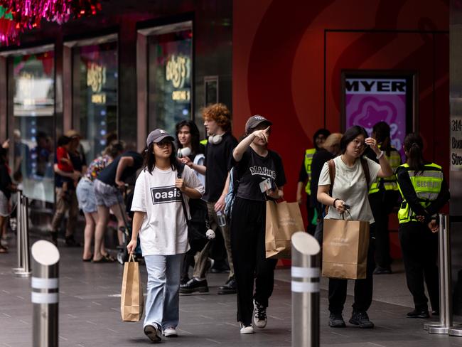 MELBOURNE, AUSTRALIA - NCA NewsWire Photos - 13 DECEMBER, 2023: People carry shopping bags while walking along Bourke Street Mall in Melbourne. Picture: NCA NewsWire / Diego Fedele