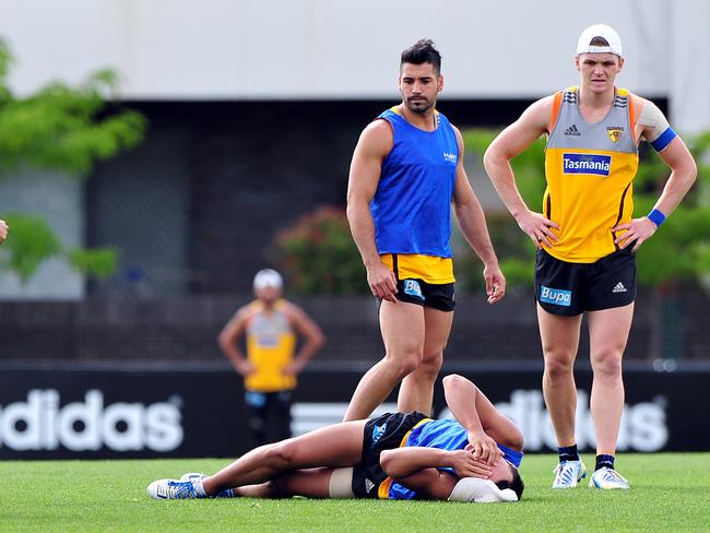 Former Hawthorn footballer Alex Woodward hurts himself at training.