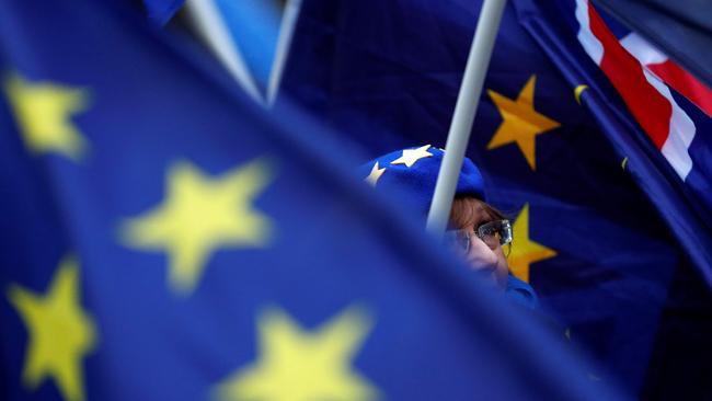 An anti-Brexit activist is draped in European Union (EU) flag and Union flags. Picture AFP.