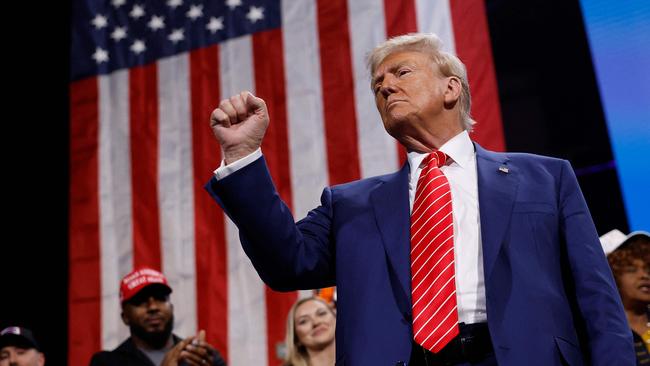 ATLANTA, GEORGIA - OCTOBER 15: Republican presidential nominee, former U.S. President Donald Trump raises his fist after delivering remarks during a campaign rally at the Cobb Energy Performing Arts Centre on October 15, 2024 in Atlanta, Georgia. With early voting starting today in Georgia both Trump and Democratic presidential nominee, Vice President Kamala Harris are campaigning in the Atlanta region this week as polls show a tight race.   Kevin Dietsch/Getty Images/AFP (Photo by Kevin Dietsch / GETTY IMAGES NORTH AMERICA / Getty Images via AFP)