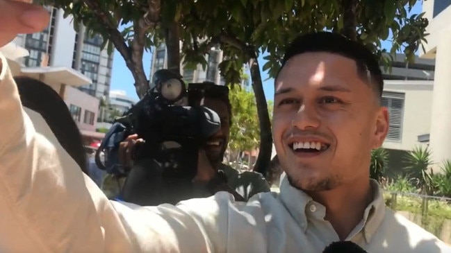 Caleb Maraku, 19, takes a selfie in front of TV cameras after receiving probation for a brutal one-punch attack in Surfers Paradise. Picture: Leanne Emery