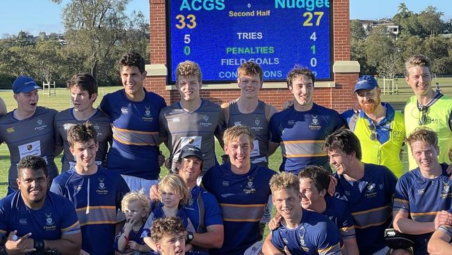 Churchie players in front of the scoreboard.