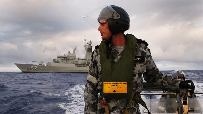 Leading seaman, boatswain’s mate, William Sharkey searching for debris alongside the HMAS Perth of missing Malaysia Airlines flight MH370 in the southern Indian Ocean on April 13, 2014.