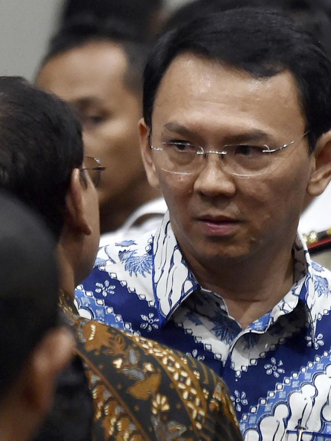 Jakarta Governor Basuki "Ahok" Tjahaja Purnama talks to his lawyers after his sentencing hearing. Photo: AP