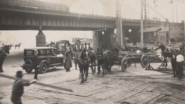 Workers at the corner of Spencer St and Flinders St during bridge construction in 1925. Picture: State Library of Victoria