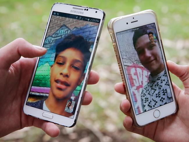 ****EMBARGOED UNTIL MONDAY JANUARY 30***Telco Optus is setting up a program for customers to donate unused phone data to students in need. Mates Tane Poka 13 (L) and Timana Williams 13 pictured using their mobile phones in Mascot. Picture: Toby Zerna