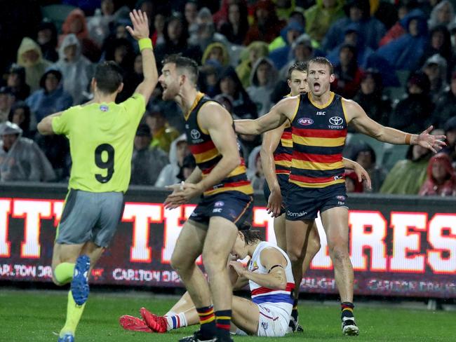 Daniel Talia of the Crows (right) questions the umpires call for a free kick during the Round 9 AFL match between the Adelaide Crows and the Western Bulldogs at the Adelaide Oval in Adelaide, Friday, May 18 2018. (AAP Image/Kelly Barnes) NO ARCHIVING, EDITORIAL USE ONLY