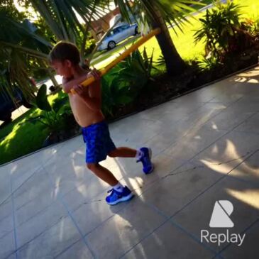 Adam Davis playing cricket on the driveway with his father