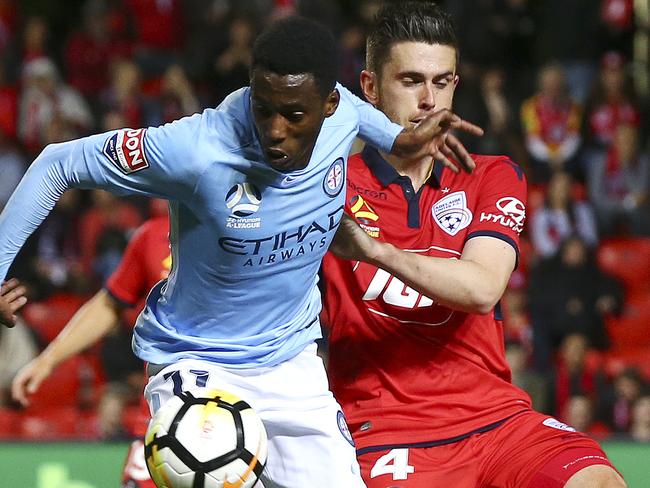 Ben Warland takes on Melbourne City’s Bruce Kamau.