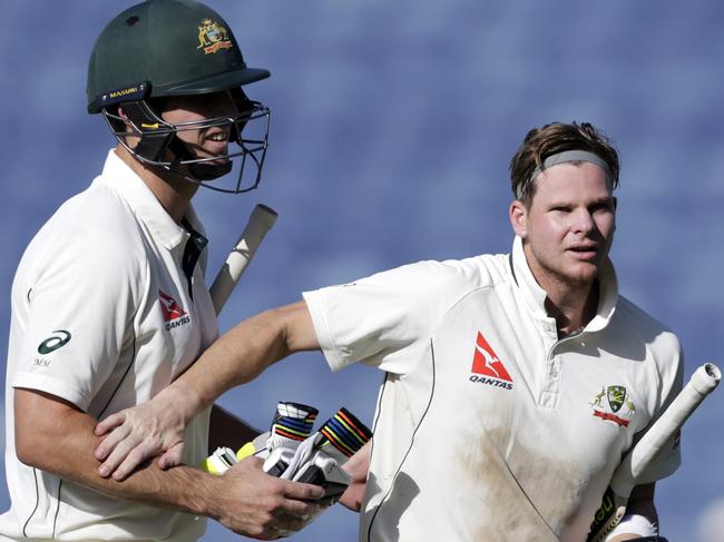 Australia's captain Steve Smith pats Mitchell Marsh at the end of the second day of the first test cricket match against India in Pune, India, Friday, Feb. 24, 2017. (AP Photo/Rajanish Kakade)