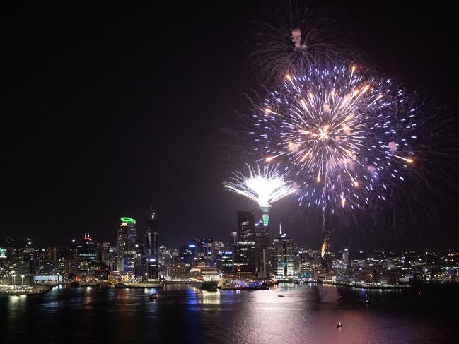 Fireworks are seen exploding from the Aucklands Waitemata Harbour and Sky Tower during Auckland New Year's Eve celebrations. Pictures: Getty