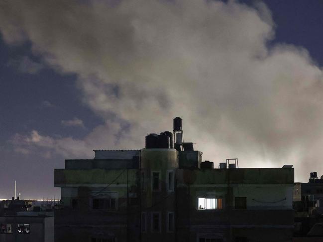 Smoke billows over buildings during Israeli bombardment south of Rafah in the southern Gaza Strip near the border with Egypt on February 17, 2024, amid ongoing battles between Israel and the Palestinian militant group Hamas. (Photo by MOHAMMED ABED / AFP)