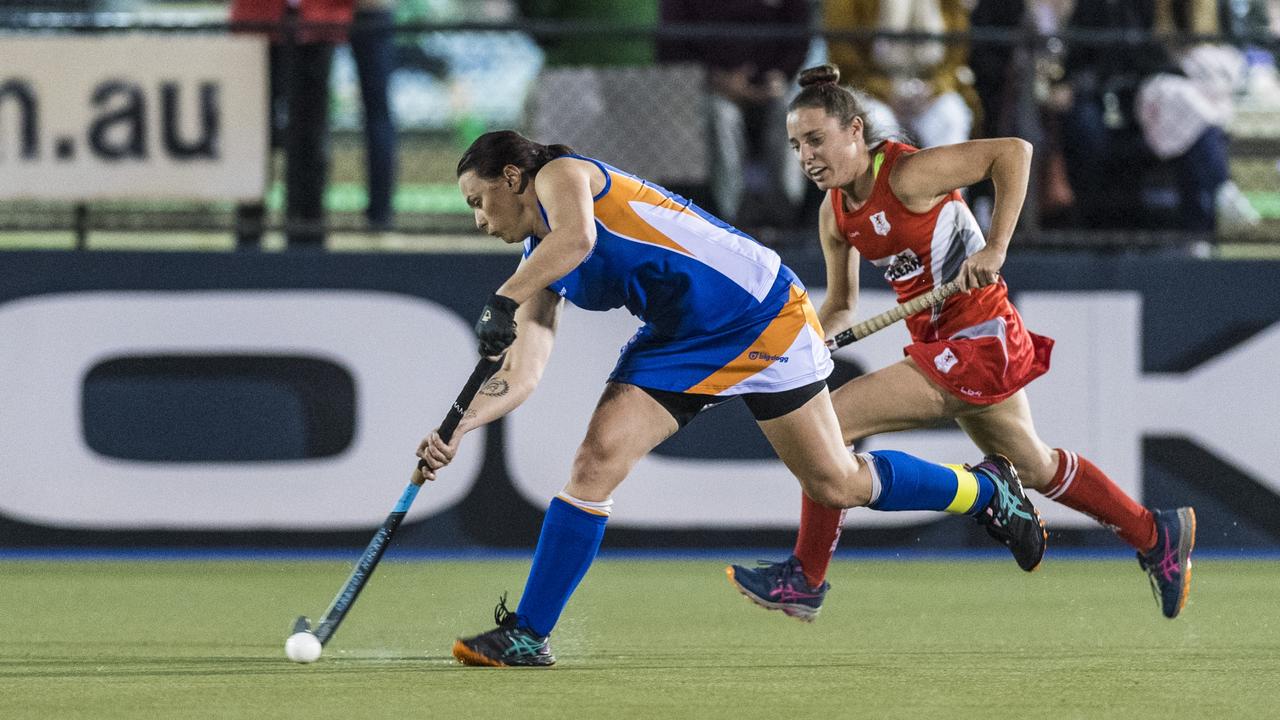 Newtown captain Amanda Ross (left) chased by Amber Suey of Red Lion in A1 womens hockey. Picture: Kevin Farmer