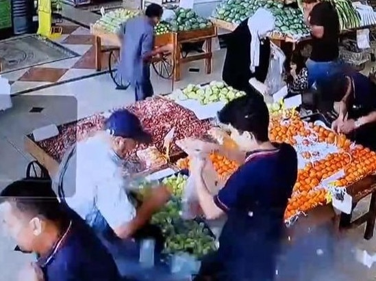 The man in the baseball cap is a Hezbollah member whose pager is about to explode as he shops.