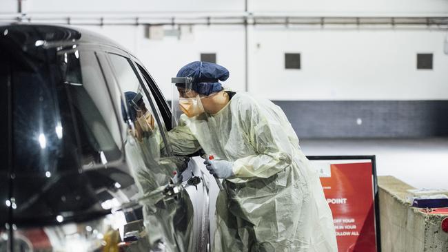 Nurses test a patient at the ACT's drive through COVID-19 testing site. Picture: Getty Images