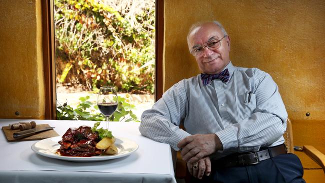 Former owner Cork &amp; Cleaver Stratos Pouras enjoying some beef ribs and a glass of red before his retirement. Picture: Mike Burton