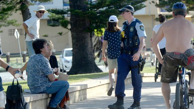 Police check on beachgoers as social distancing regulations continue at Dee Why Beach. Picture: Jeremy Piper