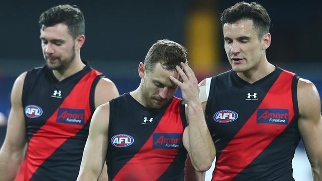 GOLD COAST, AUSTRALIA - JULY 17: Devon Smith and Mitch Hibberd of the Bombers leave the field after losing the round 7 AFL match between the Essendon Bombers and the Western Bulldogs at Metricon Stadium on July 17, 2020 in Gold Coast, Australia. (Photo by Chris Hyde/Getty Images)