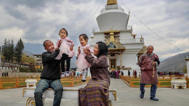 Dad Sonam, Nima, Dawa, and mum Bhumchu take the them to the Memorial Chorten Buddhist temple in Thimphu. Picture: Alex Coppel. 