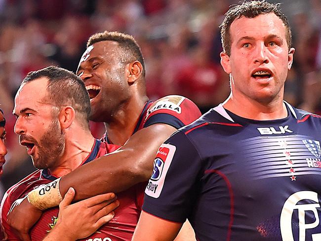 Jono Lance of the Reds (2nd left) celebrates with team mates after scoring a try during the Rd 18 Super Rugby match between the Queensland Reds and the Melbourne Rebels at Suncorp Stadium in Brisbane, Friday, July 6, 2018. (AAP Image/Albert Perez) NO ARCHIVING, EDITORIAL USE ONLY