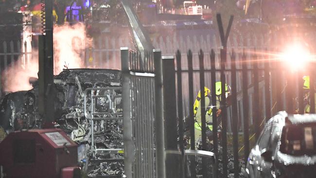 Emergency services work at the scene on the wreckage of a helicopter that crashed in a car park outside Leicester City Football Club