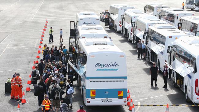 Mallacoota evacuees board buses bound for a relief centre on the Mornington Peninsula. Picture: Ian Currie