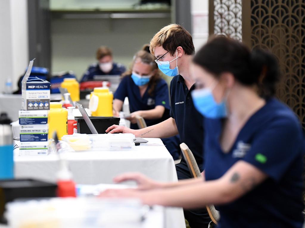 Health workers at a pop up Covid-19 vaccination clinic at Brisbane City Hall. Picture: NCA NewsWire / Dan Peled