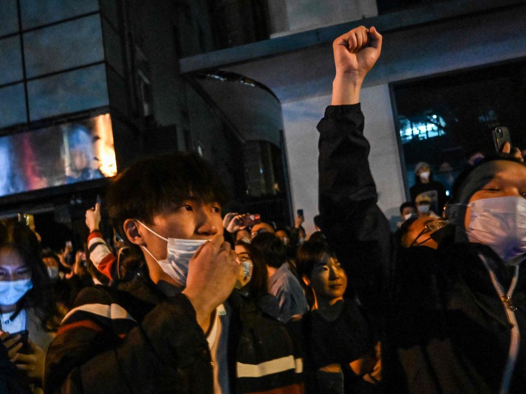 People sing slogans while gathering on a street during the first clashes in Shanghai. Picture: AFP